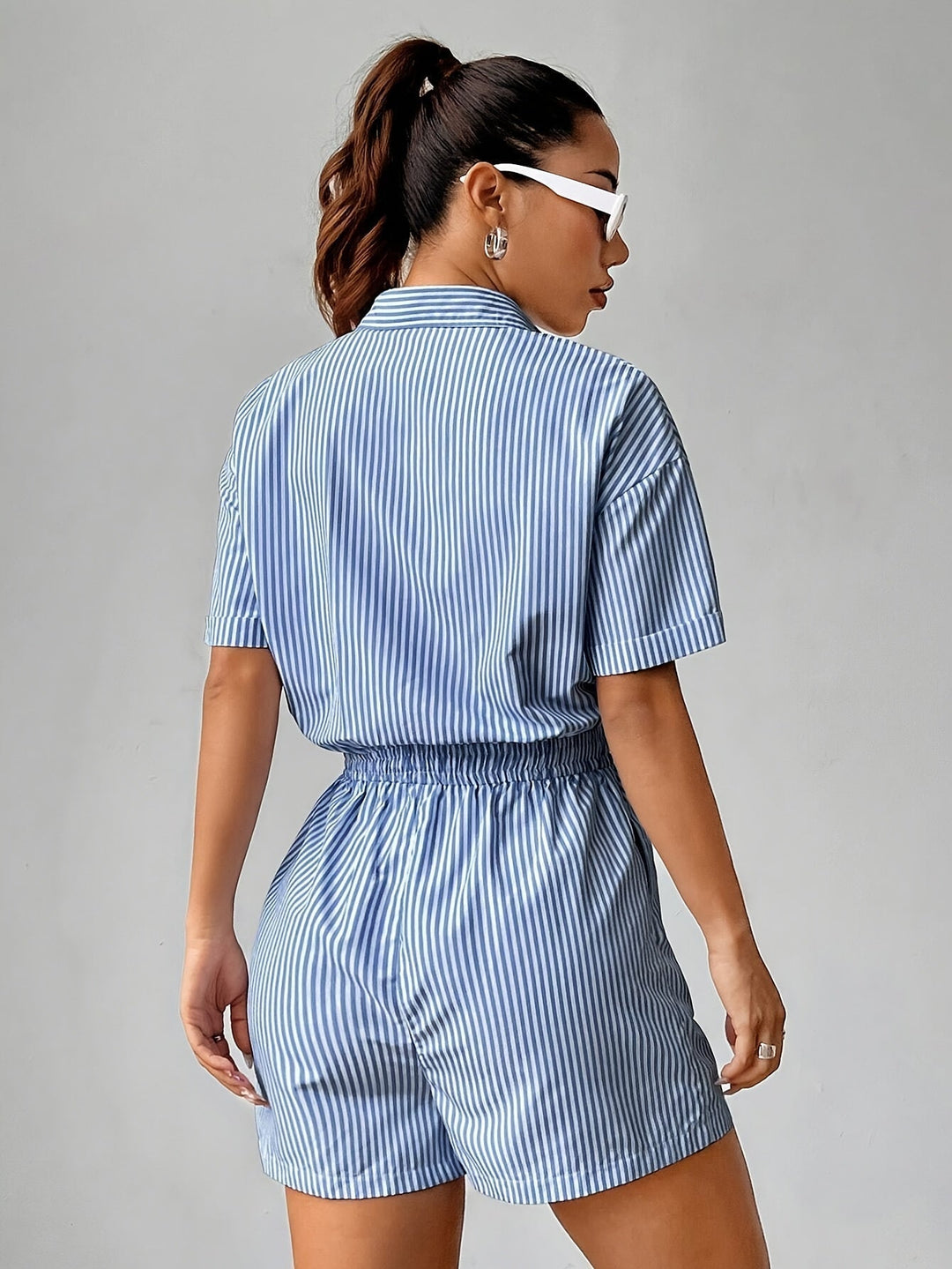 Casual women's striped summer jumpsuit with comfy short sleeves, perfect for warm weather.