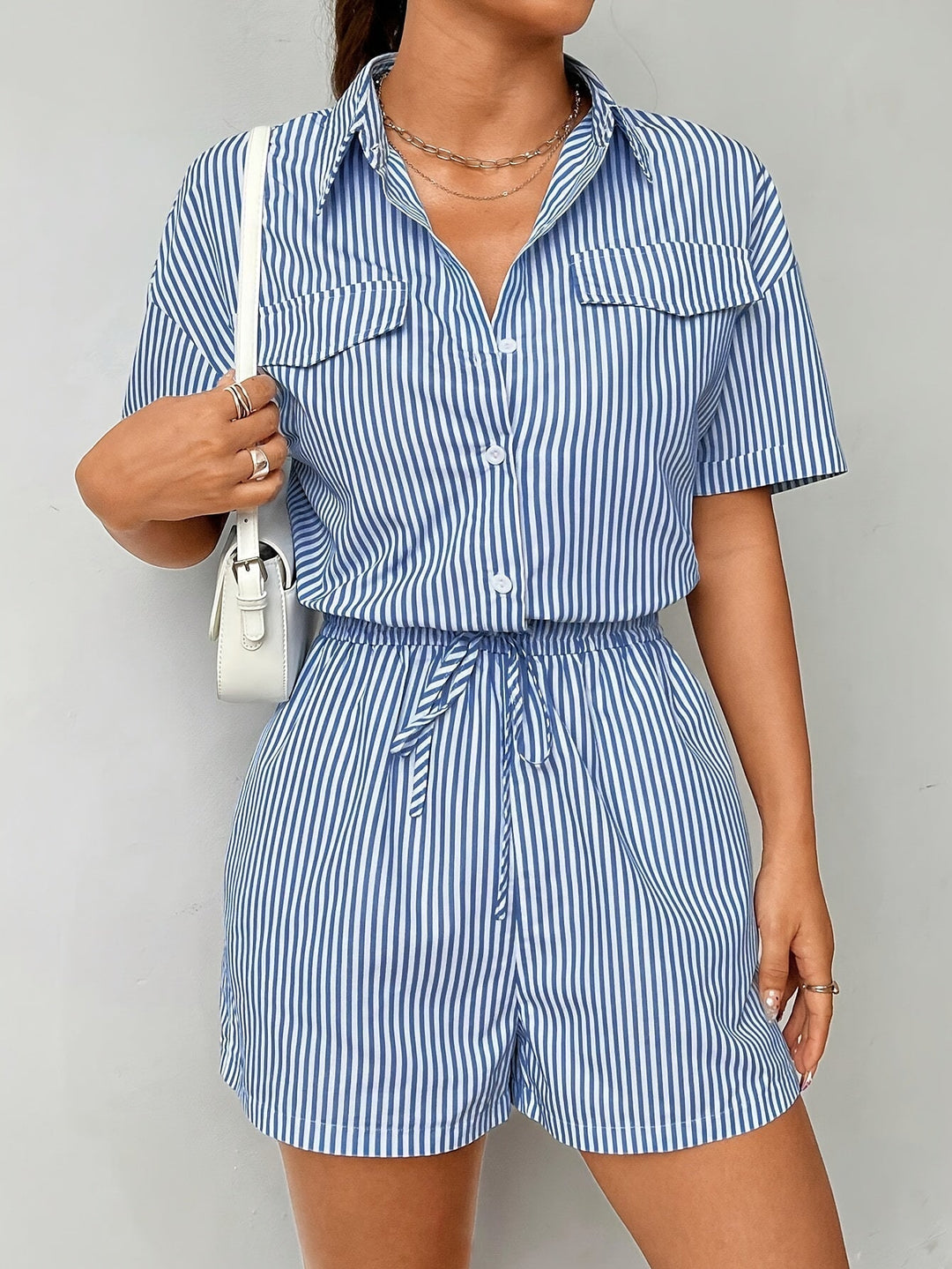 Trendy women's striped short sleeve jumpsuit featuring a button front design.