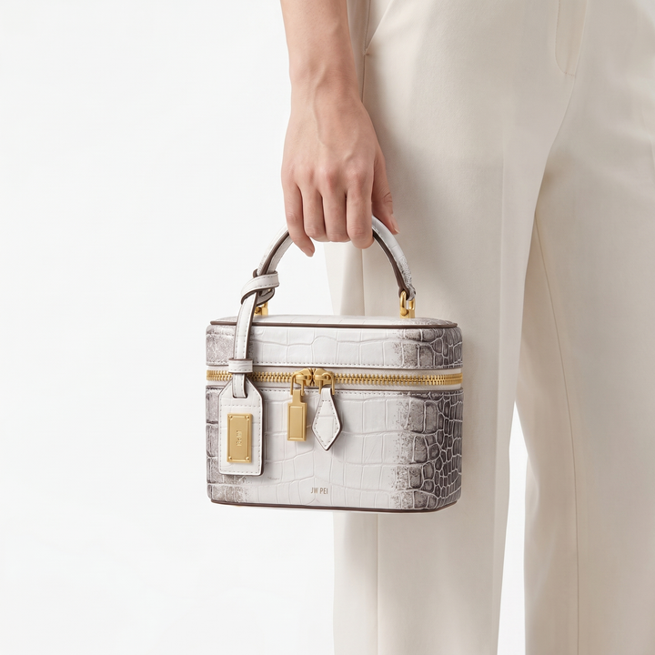 Chic women's box bag; structured design with luxurious embossed crocodile texture. A must-have accessory.
