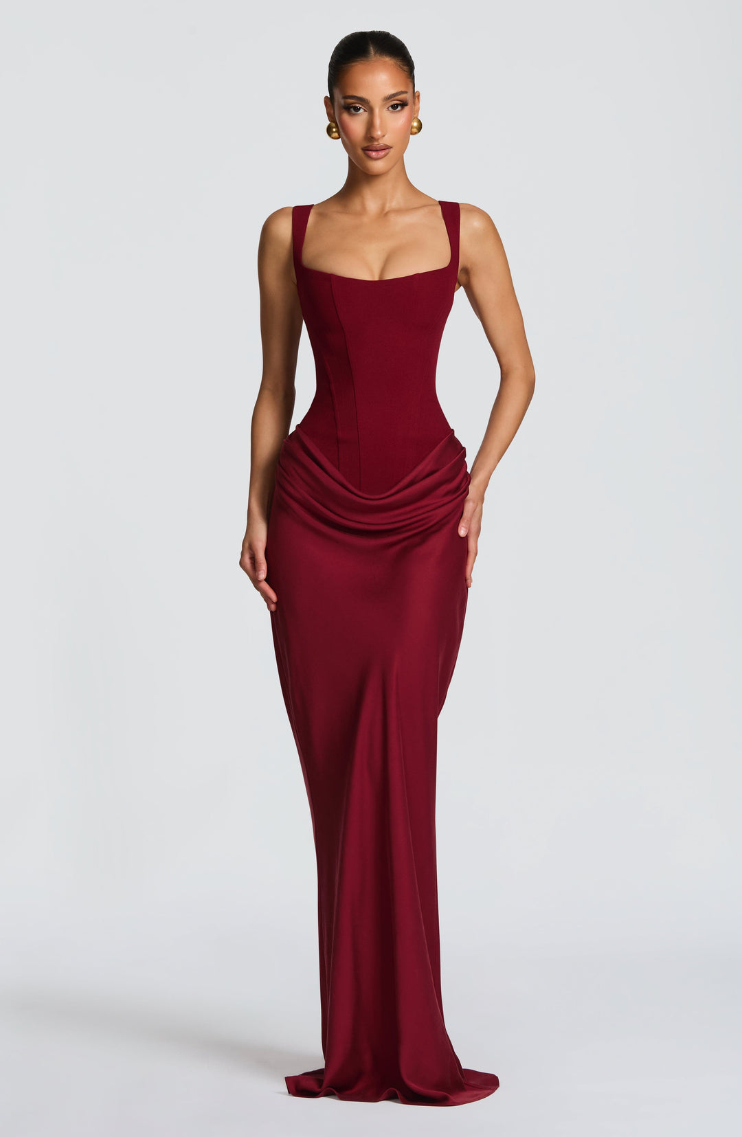 Women's structured corset maxi dress with wide straps, elegant for evening wear.