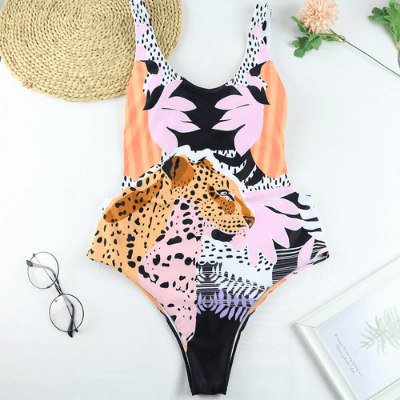 Close-up of animal print pattern on women's one-piece swimsuit, tiger print design