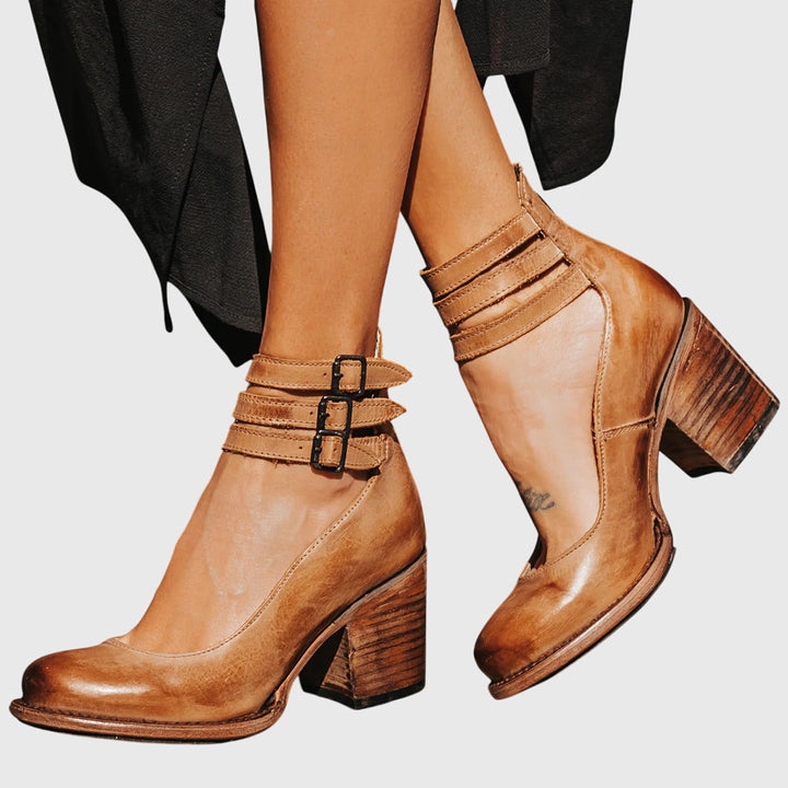 Western-style women's fashion ankle boots featuring a chic buckle and sturdy block heel.