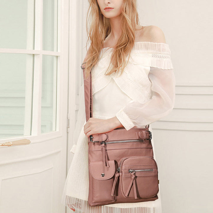 Black anti-theft crossbody bag for women, featuring secure zippers & stylish design.