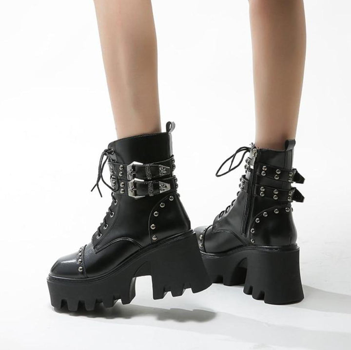 Durable black women's platform ankle boots, designed for comfort and confident strides, with a trendy edge.