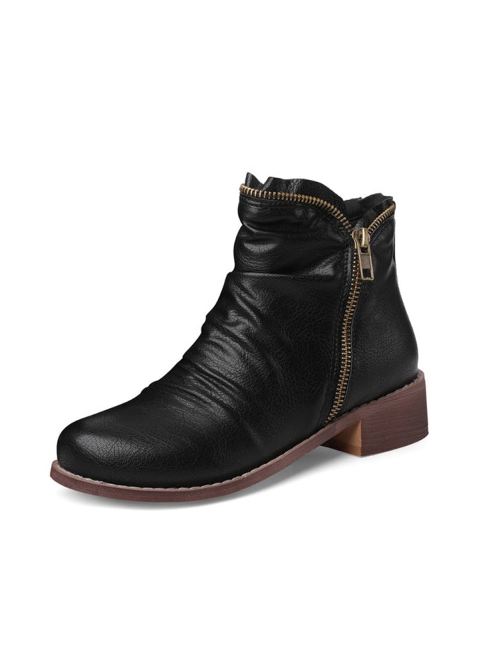 Women's stylish black wrinkled western ankle boots with double zipper, low heel, and round toe. Fall fashion.