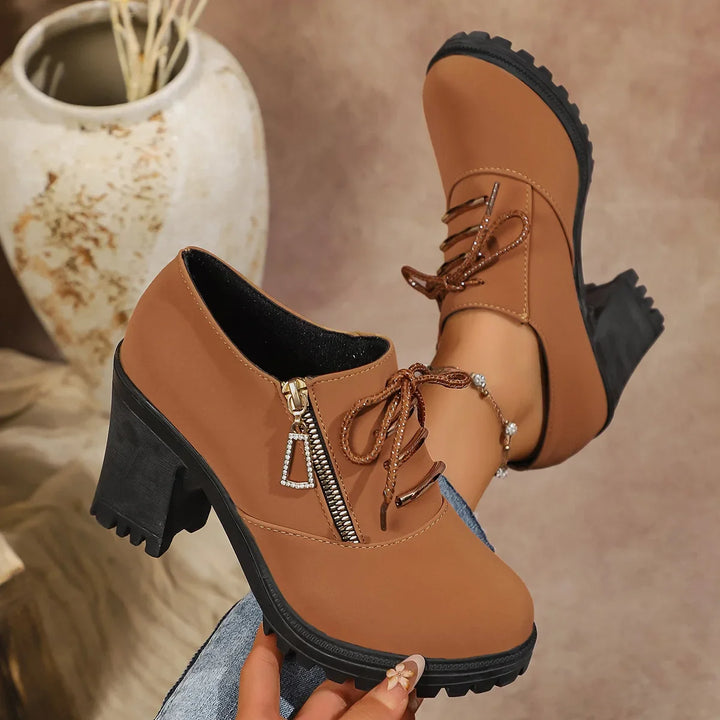 Stylish women's lace-up block heels with a subtle zipper accent, ideal for modern fashion looks.