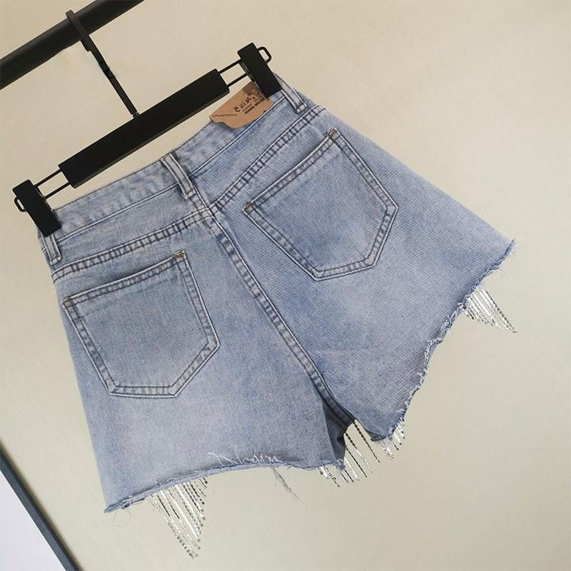 Boho chic women's blue shorts featuring stylish tassels, perfect for summer casual wear and beach days.