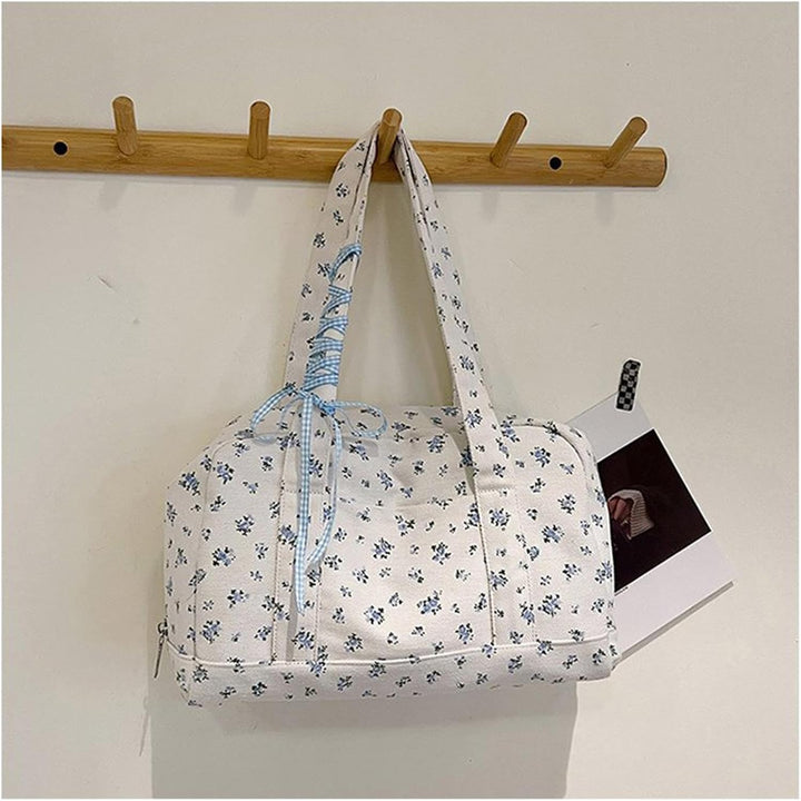 Stylish women's travel accessory: large canvas duffle bag with a sophisticated bow accent