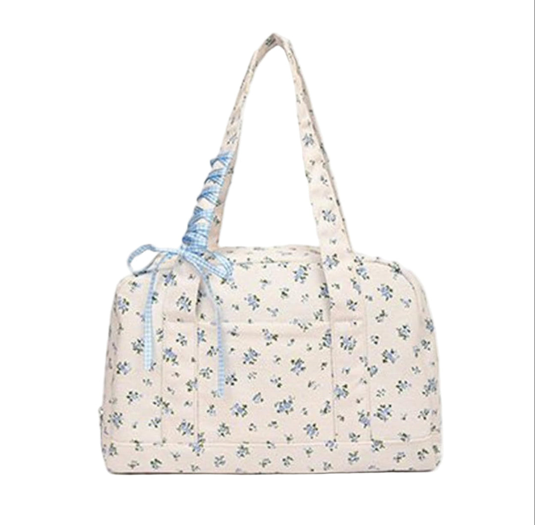Women's chic canvas bow duffle bag, large weekender featuring a unique ribbon design, travel