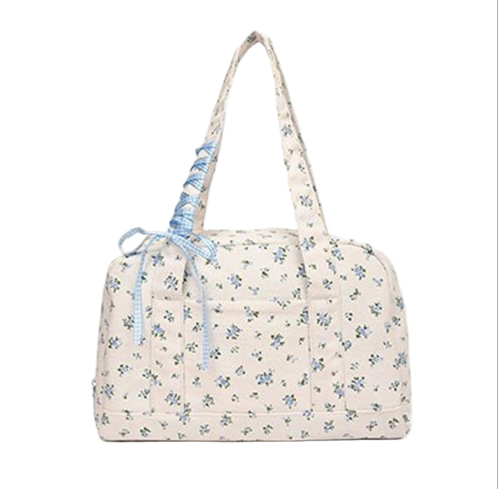 Women's chic canvas bow duffle bag, large weekender featuring a unique ribbon design, travel