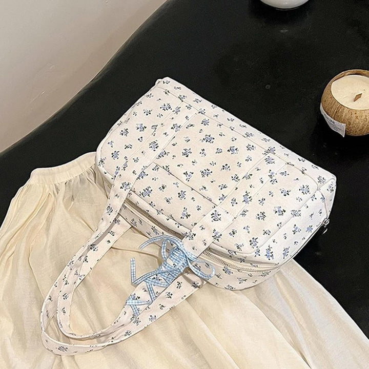 Floria large canvas duffle bag carried by a woman, stylish weekender with prominent bow accent