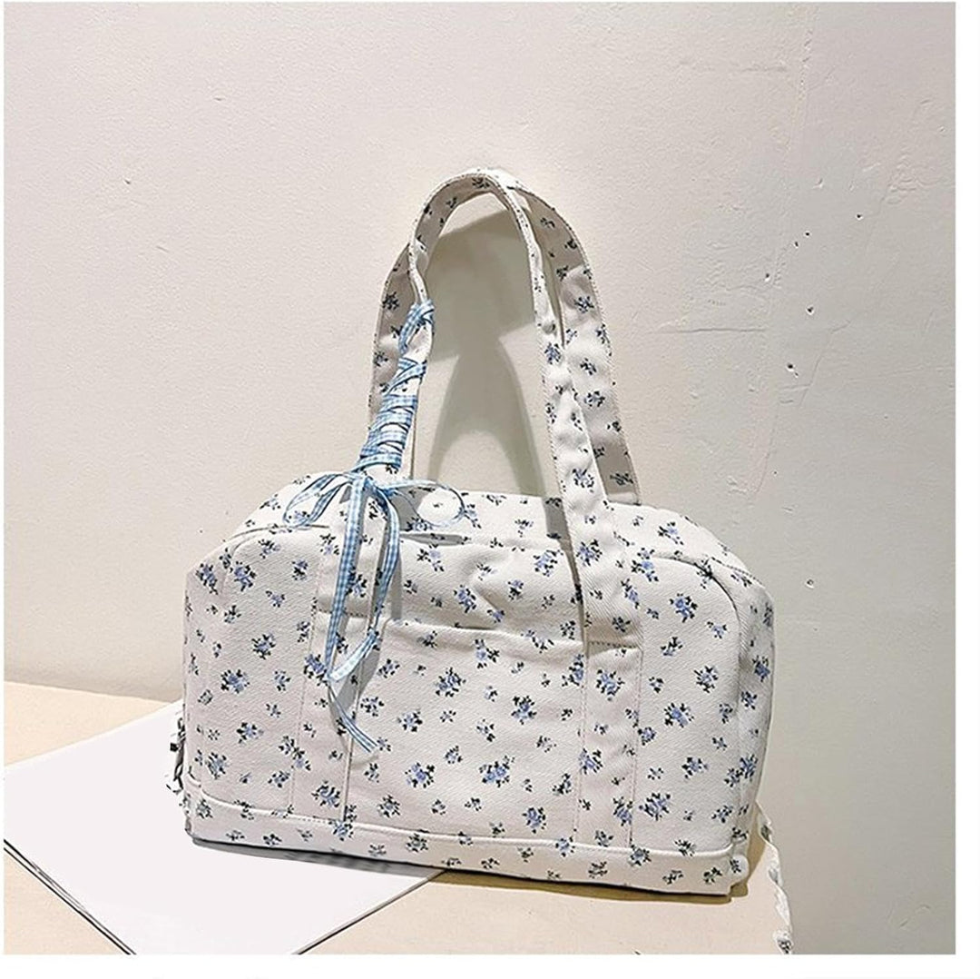 Detailed shot of canvas texture and elegant bow on Floria women's large duffle weekender bag