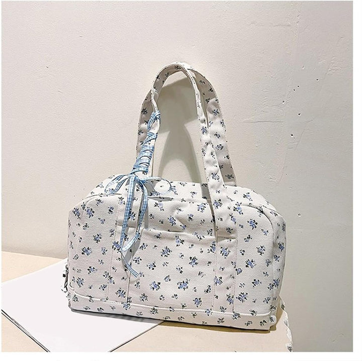 Detailed shot of canvas texture and elegant bow on Floria women's large duffle weekender bag