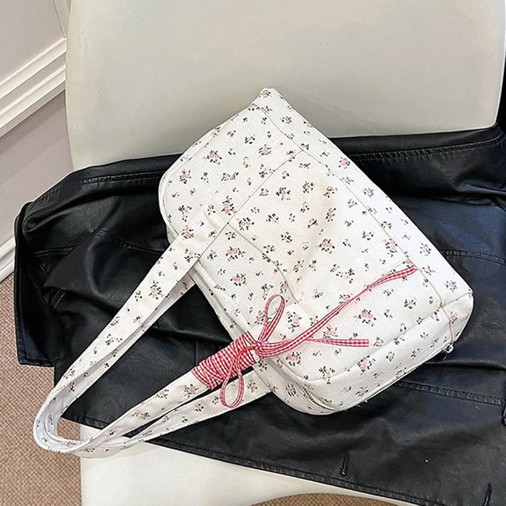 Close-up of the bow accent on a Floria large canvas duffle bag, women's stylish weekender