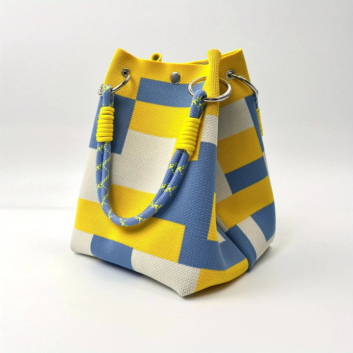 Women's stylish canvas mini bucket bag with unique design. Versatile shoulder or crossbody compact fashion accessory.