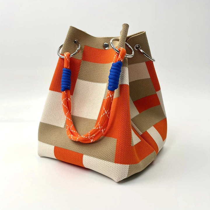 Compact women's canvas mini bucket bag featuring unique patchwork design. A stylish shoulder & crossbody fashion accessory.