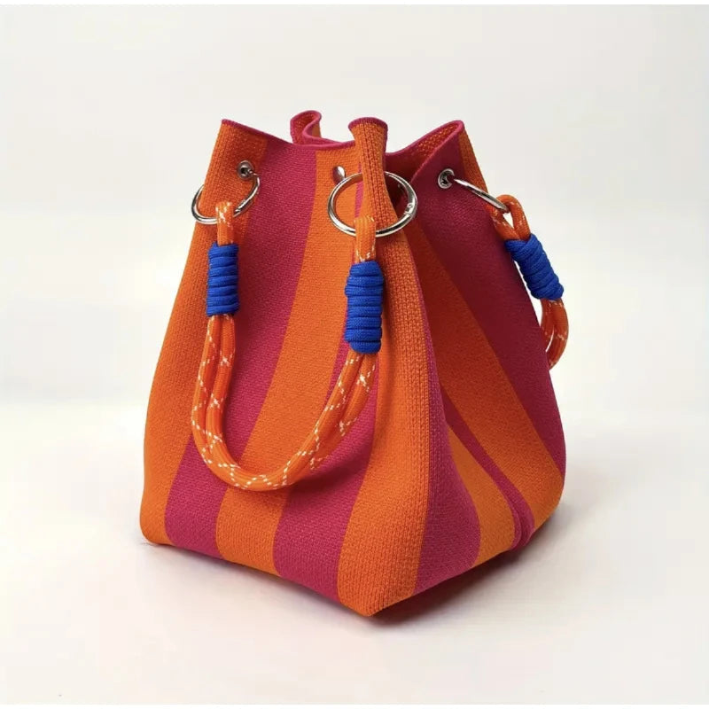 Stylish women's canvas mini bucket bag. Features a unique striped design. Perfect compact shoulder or crossbody fashion accessory.