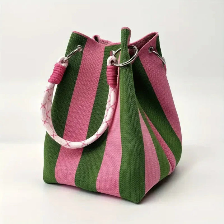 Lifestyle shot of women's stylish canvas mini bucket bag. Unique design, perfect compact shoulder or crossbody fashion accessory.