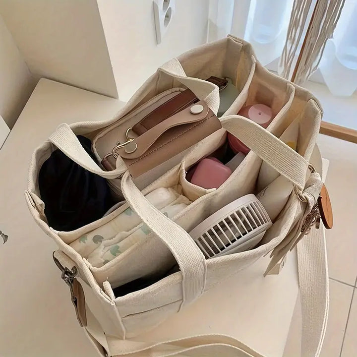 Durable canvas shoulder bag for women, ideal as a work tote, shopping bag, or travel carryall. Secure zipper.