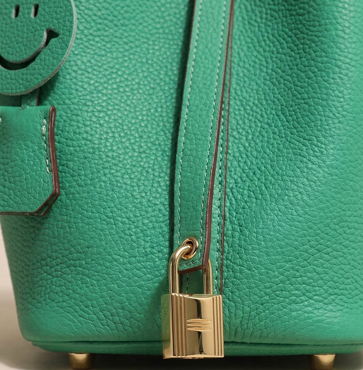 Women's high-quality cowhide leather bucket bag, a stylish and durable daily use handbag with gold details.
