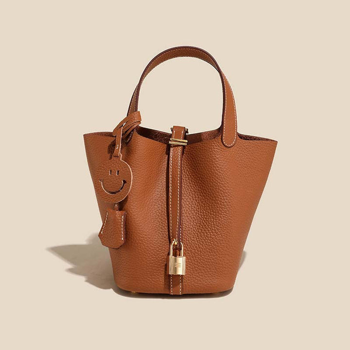 Brown leather bucket bag, a timeless women's fashion accessory, versatile for daily use and styling.