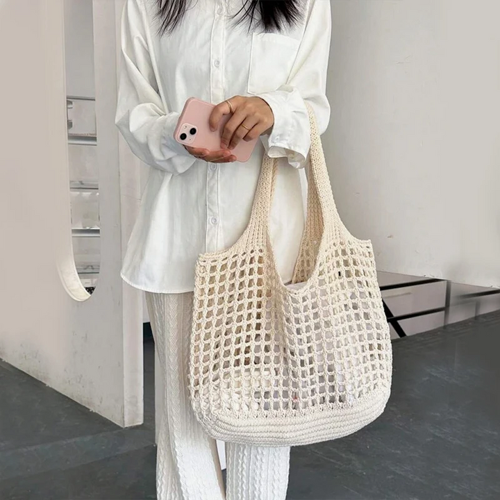 Versatile women's shoulder bag: a fashionable crochet carryall for market or travel.