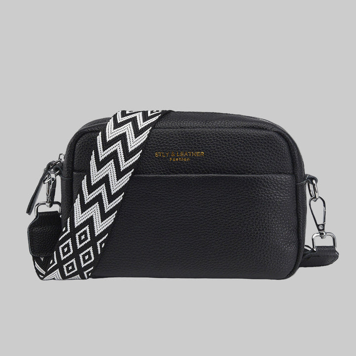 Women's stylish crossbody bag with unique geometric strap. Versatile everyday fashion accessory.