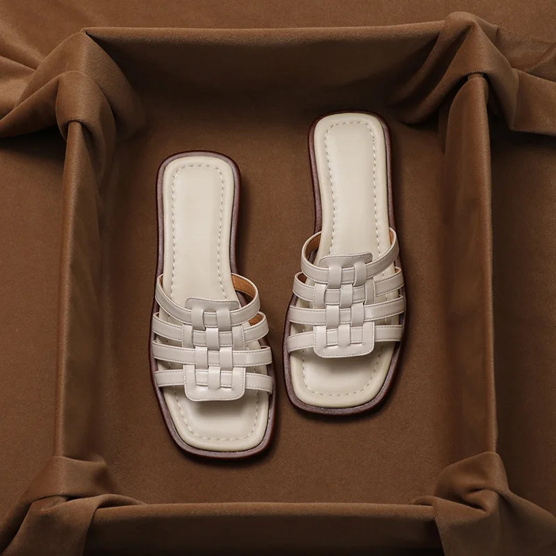 A woman wearing comfortable brown geo cutout slide sandals, perfect for summer casual outings.