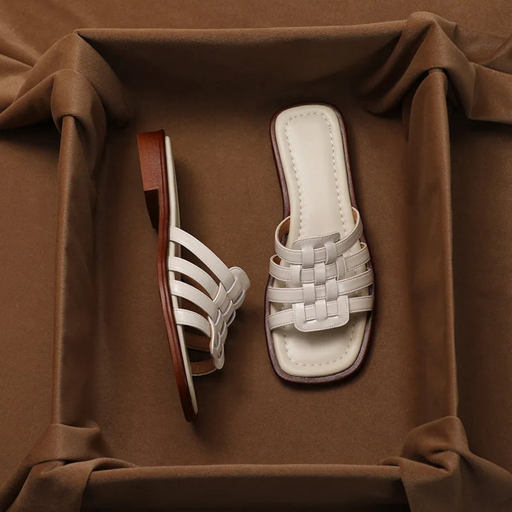 Cushioned women's brown flat slide sandals with a chic geo cutout design for all-day comfort.