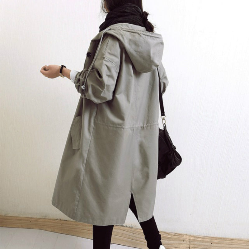 Elegant women's hooded trench coat, a fashionable long outerwear for all-weather style and protection.