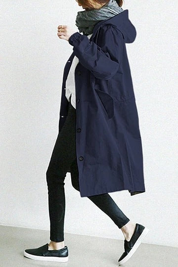Hooded trench coat for women, offering reliable all-weather protection. Stylish and versatile outerwear.