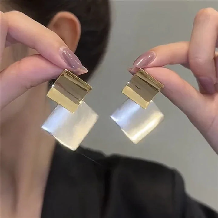 Modern layered square clash earrings for women. Two-tone silver and gold, a stylish statement fashion accessory.