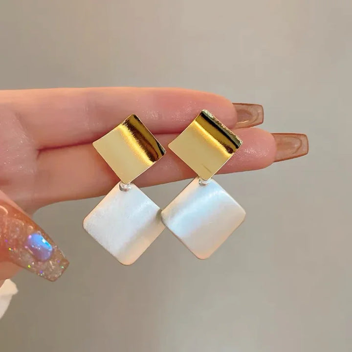 Chic women's layered square clash earrings. Stylish two-tone silver and gold design, perfect modern fashion jewelry.
