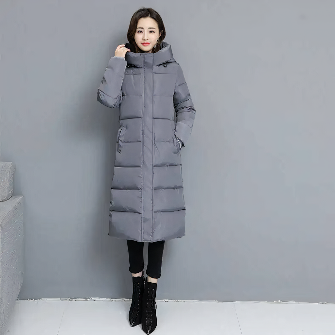 Elegant long quilted winter coat for women. Stylish padded jacket, ideal for cold weather and fashion.