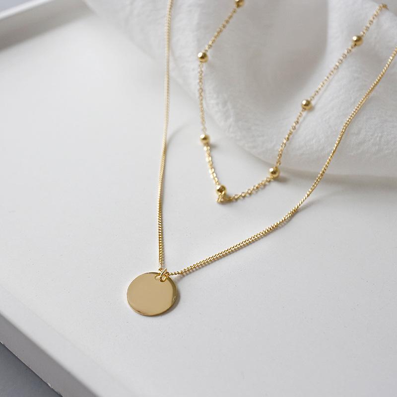 Women's stylish multilayer necklace. Elegant gold-tone accessory, perfect fashion statement & gift for her.