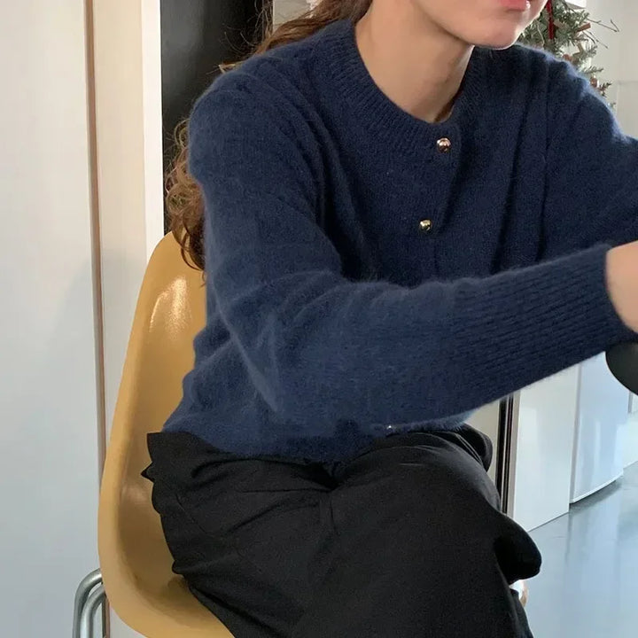 Blue women's knitted o-neck cardigan. Soft, versatile fall/winter layering piece for elegant casual wear.