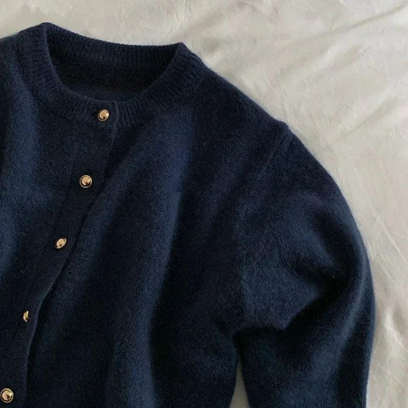 Women's stylish o-neck knitted cardigan. Effortless style for casual wear or elegant layering. Wardrobe essential.