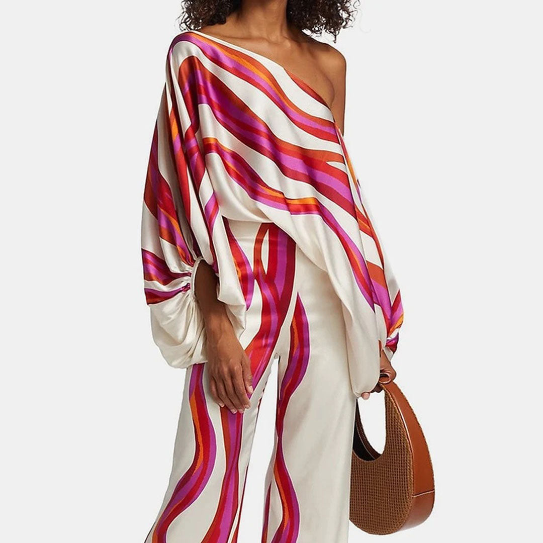 Women's elegant off-shoulder two-piece summer set. Featuring a printed top with lantern sleeves & matching shorts.