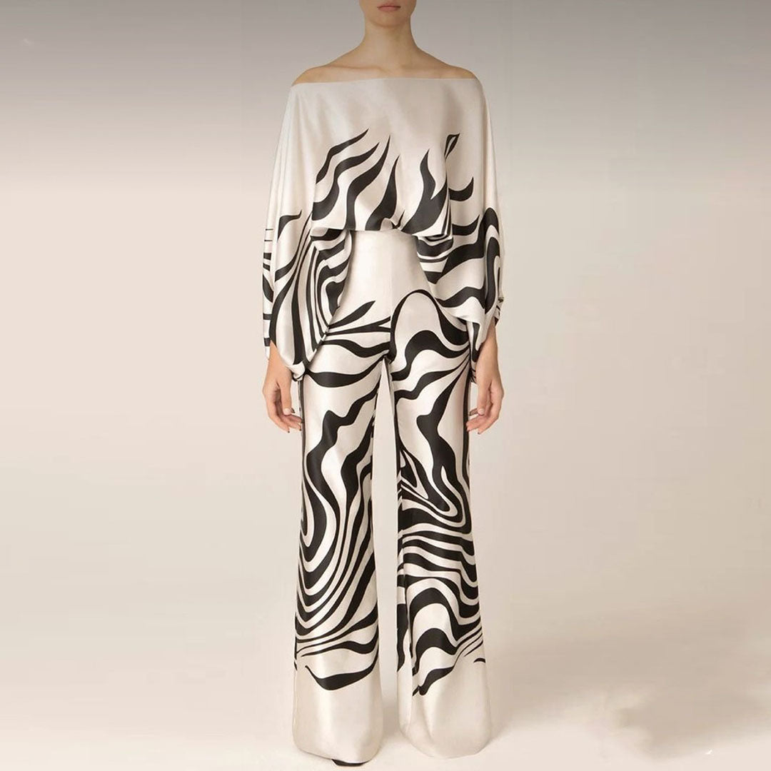 Women's summer off-shoulder two-piece set. Printed lantern sleeve top & matching shorts, ideal vacation clothing.