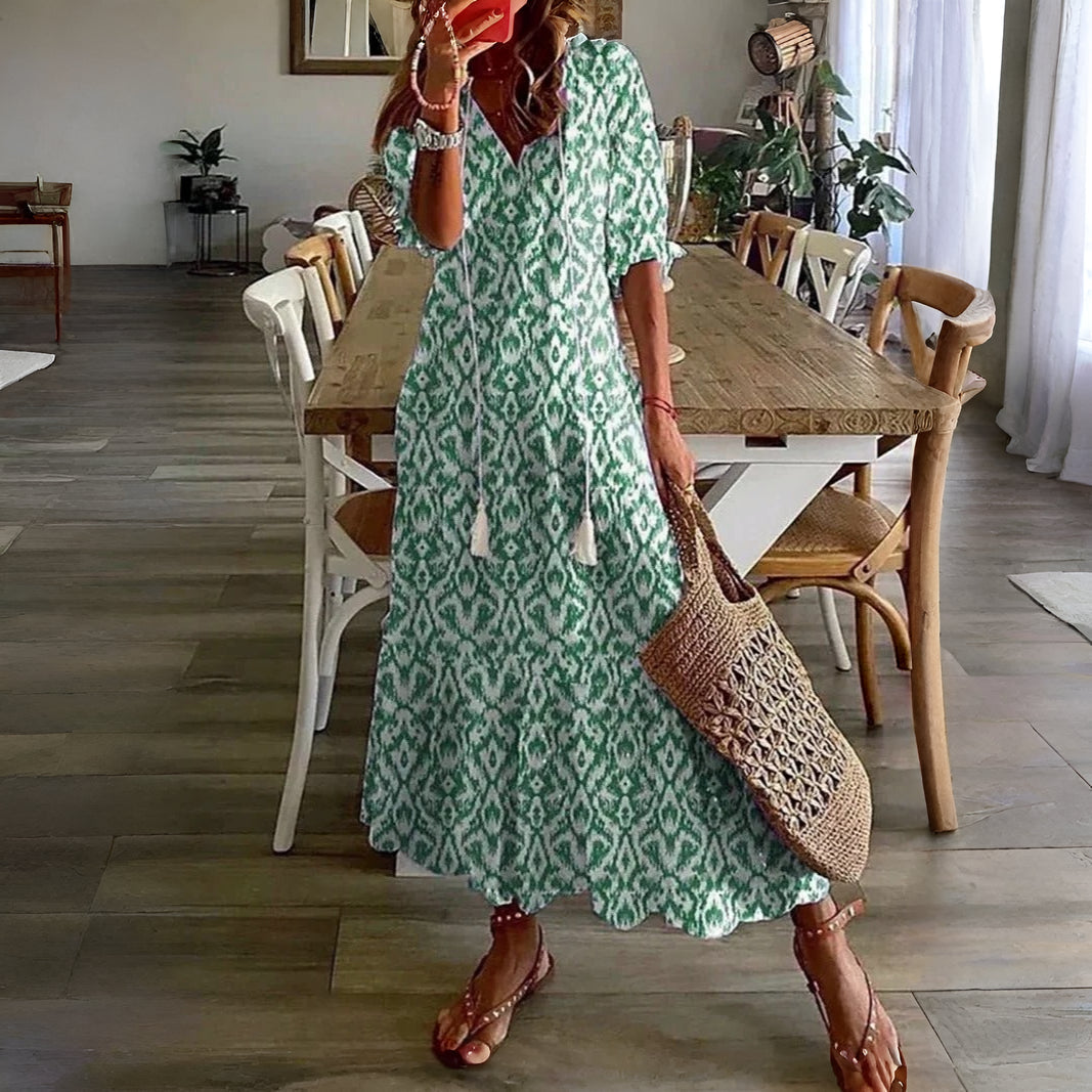 Vibrant printed women's summer midi dress, stylish half sleeve design, comfortable for warm weather & vacations.