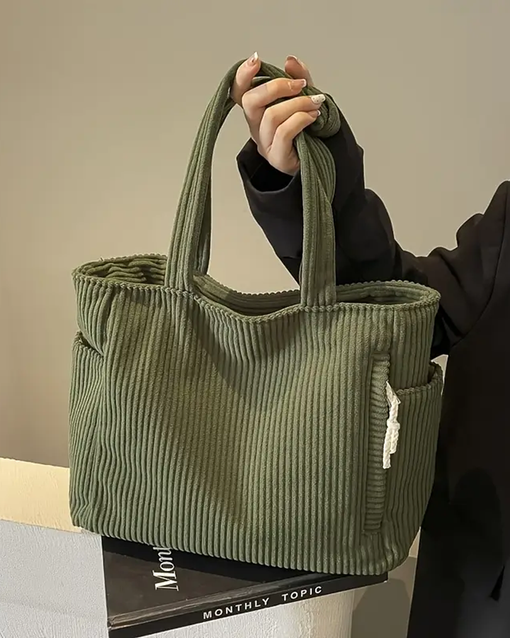 Women's stylish ribbed tote bag with unique cord detail, a spacious everyday shoulder bag for fashion.