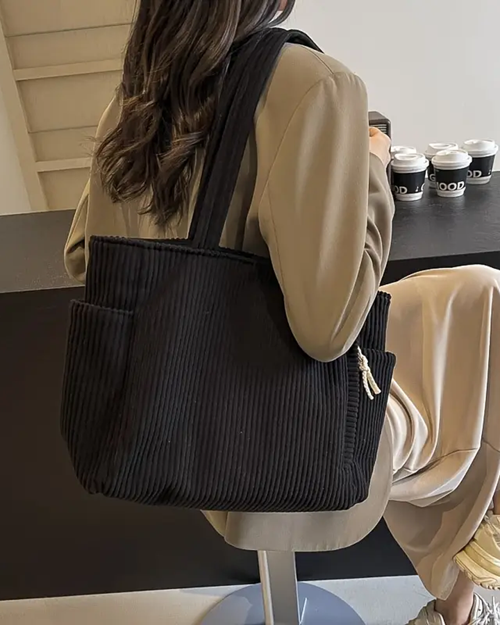 Modern women's ribbed tote bag, an everyday carryall. Distinctive cord detail adds a stylish touch.