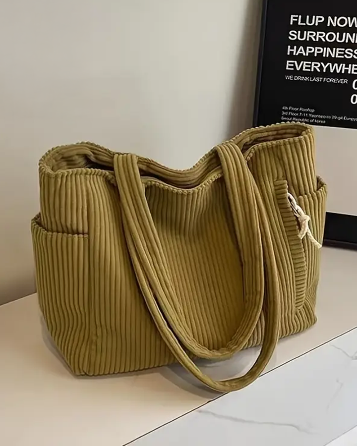 Women's stylish ribbed shoulder bag, featuring unique cord detail. A spacious and versatile everyday tote.