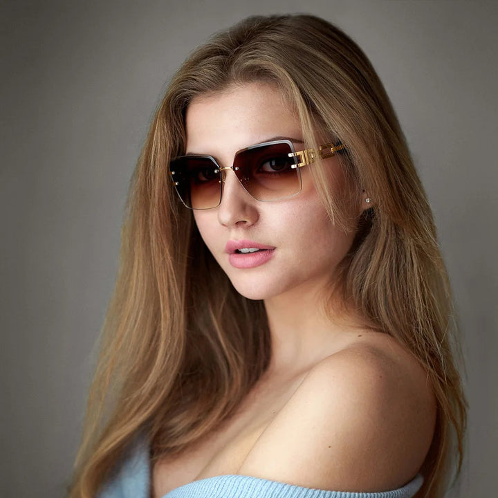 Stylish women's sunglasses: rimless square frames with decorative chain link temples for eye protection.