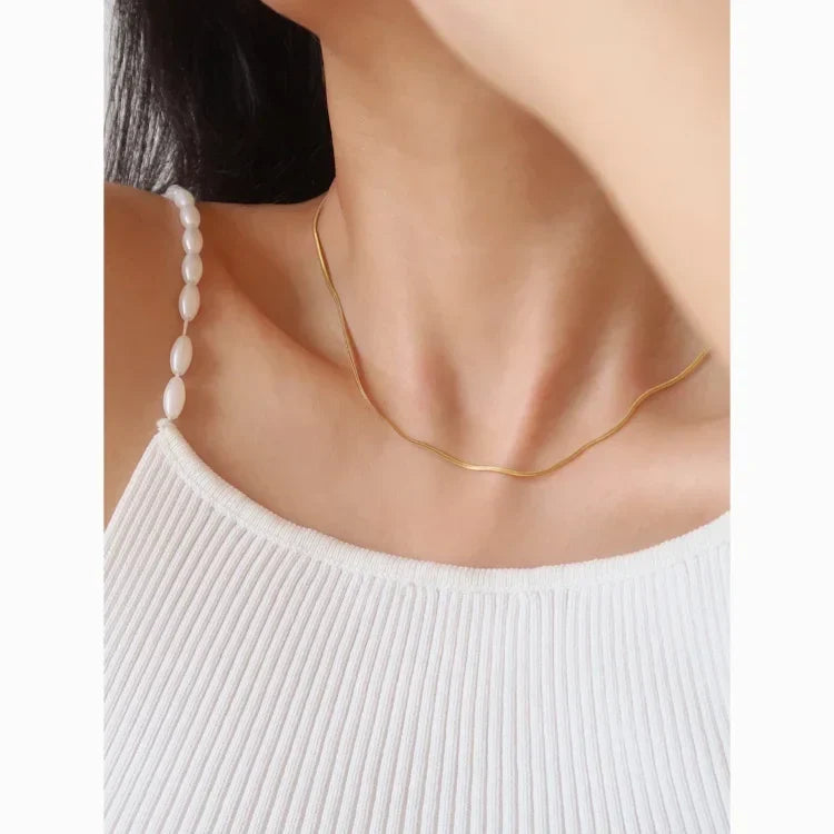 Women's stylish slim snake chain necklace in sterling silver, elegant and minimalist jewelry.