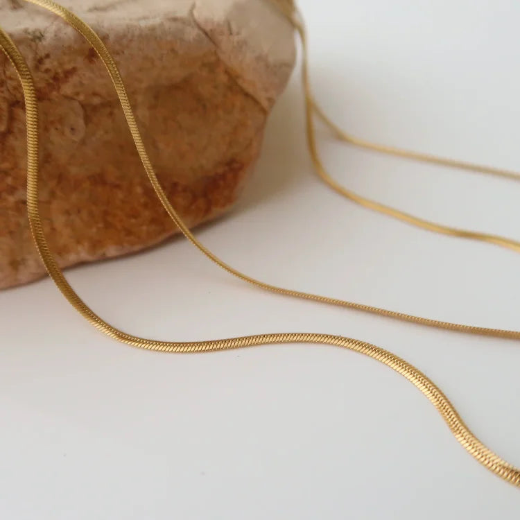 Elegant gold plated women's snake chain necklace, perfect for versatile layering or a minimalist look.
