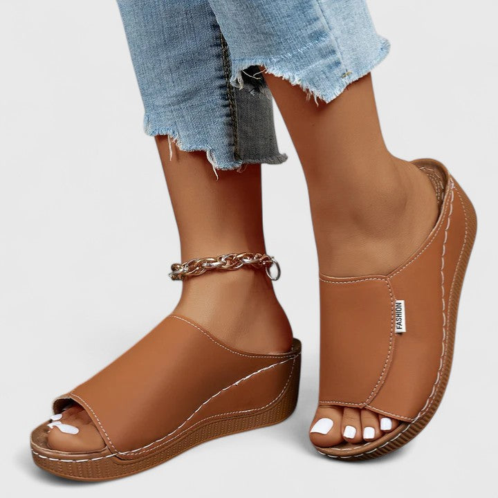 Woman wearing stylish women's summer sandals, walking outdoors. Perfect lightweight travel footwear.