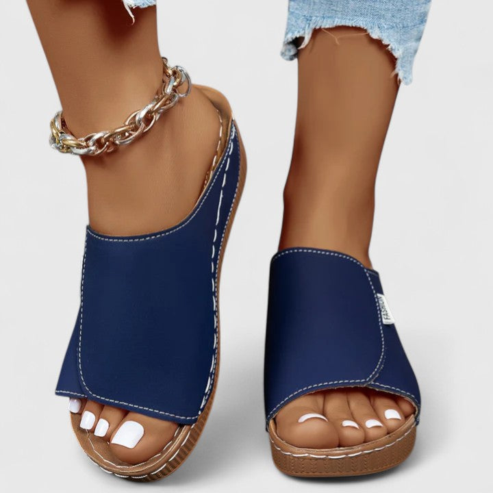 Black women's slip-on comfort sandals, offering elegant style & lightweight support for summer.