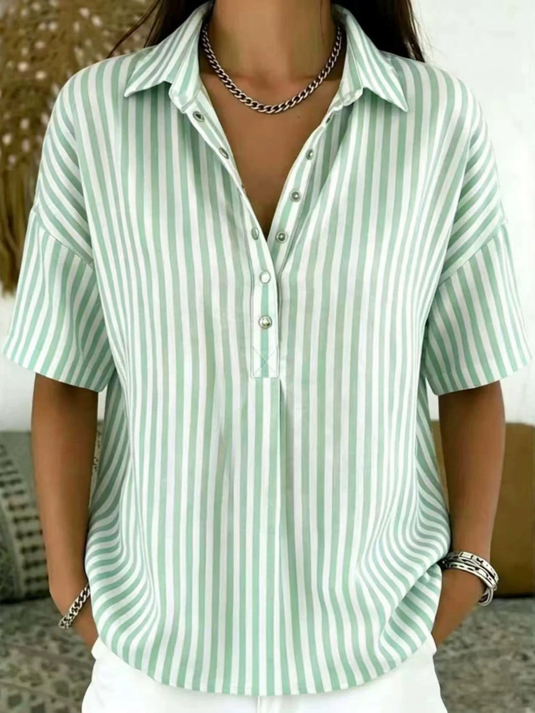 Women's stylish vertical stripe half-button blouse, perfect for casual or office wear.