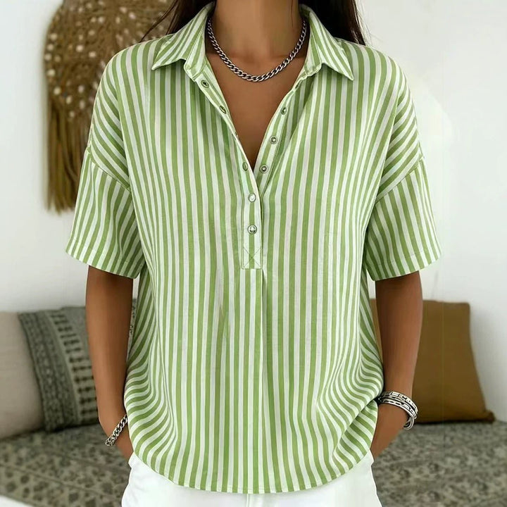 Elegant women's blouse with vertical stripes and a half-button placket, ideal for spring fashion.